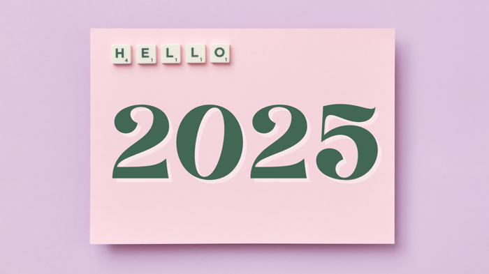 A photo of a pink card with Scrabble letters reading "Hello" and the text 2025 in big green font below