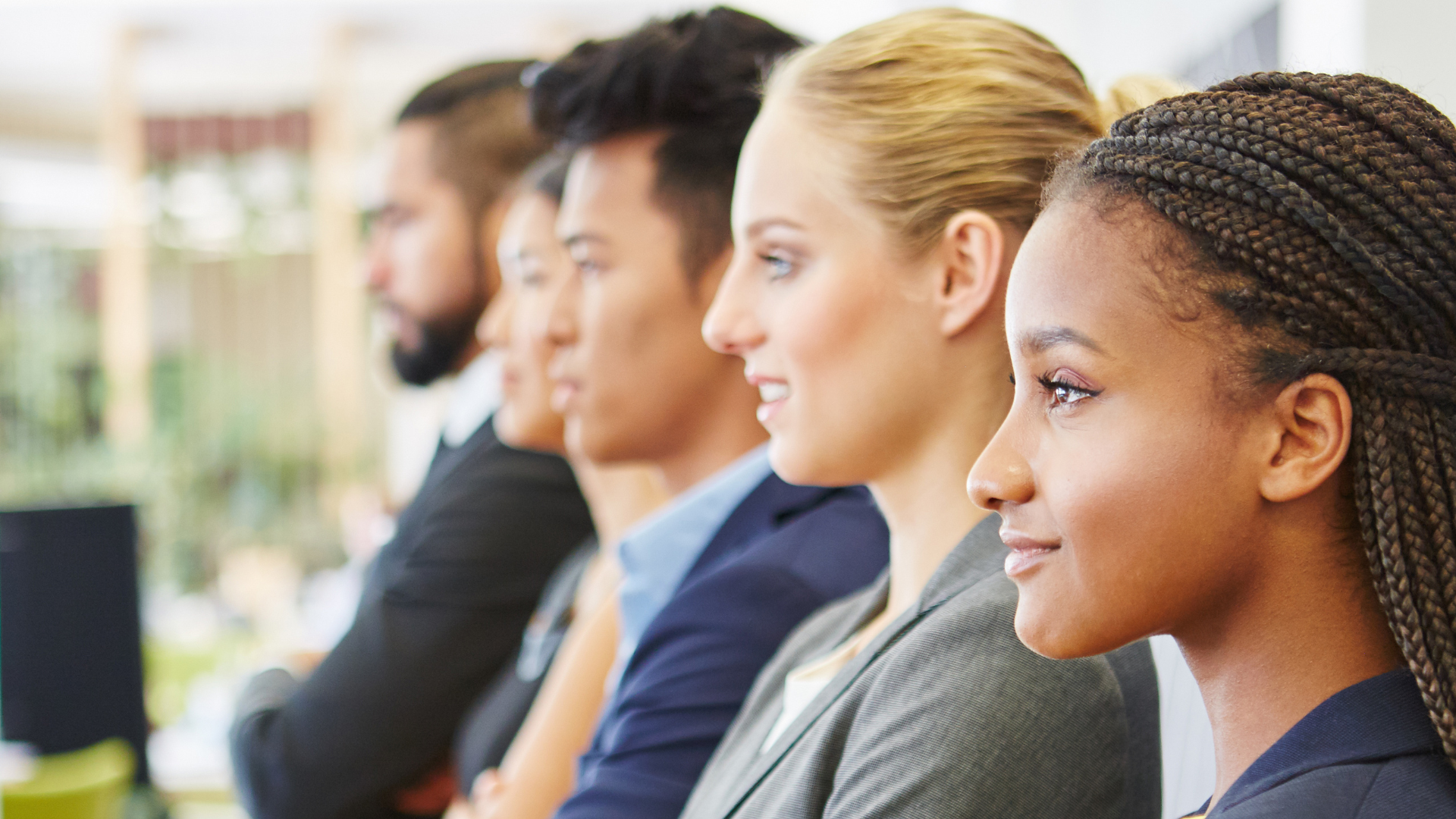 Side view of five different office people standing in a line
