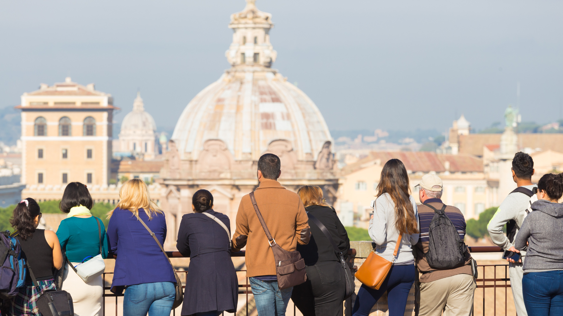 A photo of tourists gazing out over an historic city's skyline