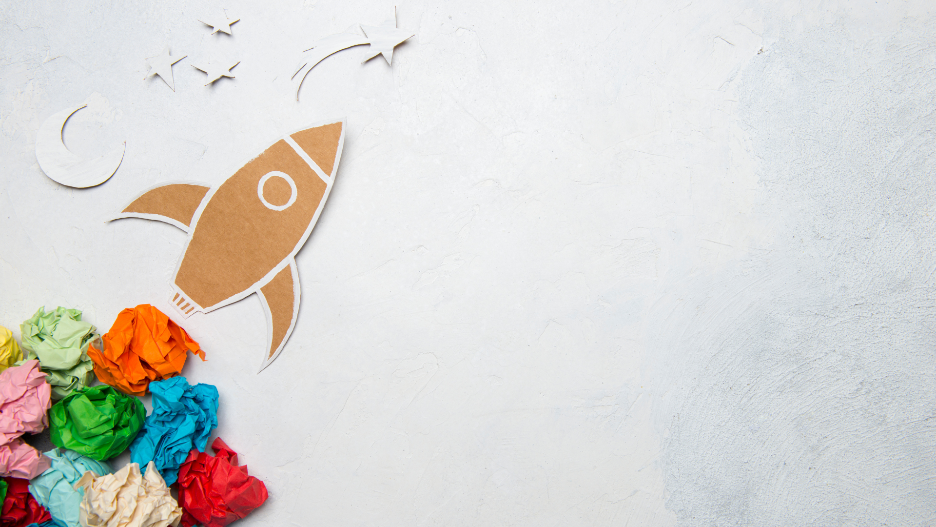 A stylized representation of a rocket launching into space made using paper craft elements. 