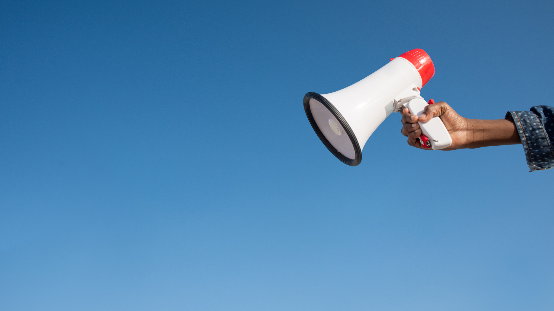 Image of a hand holding a megaphone