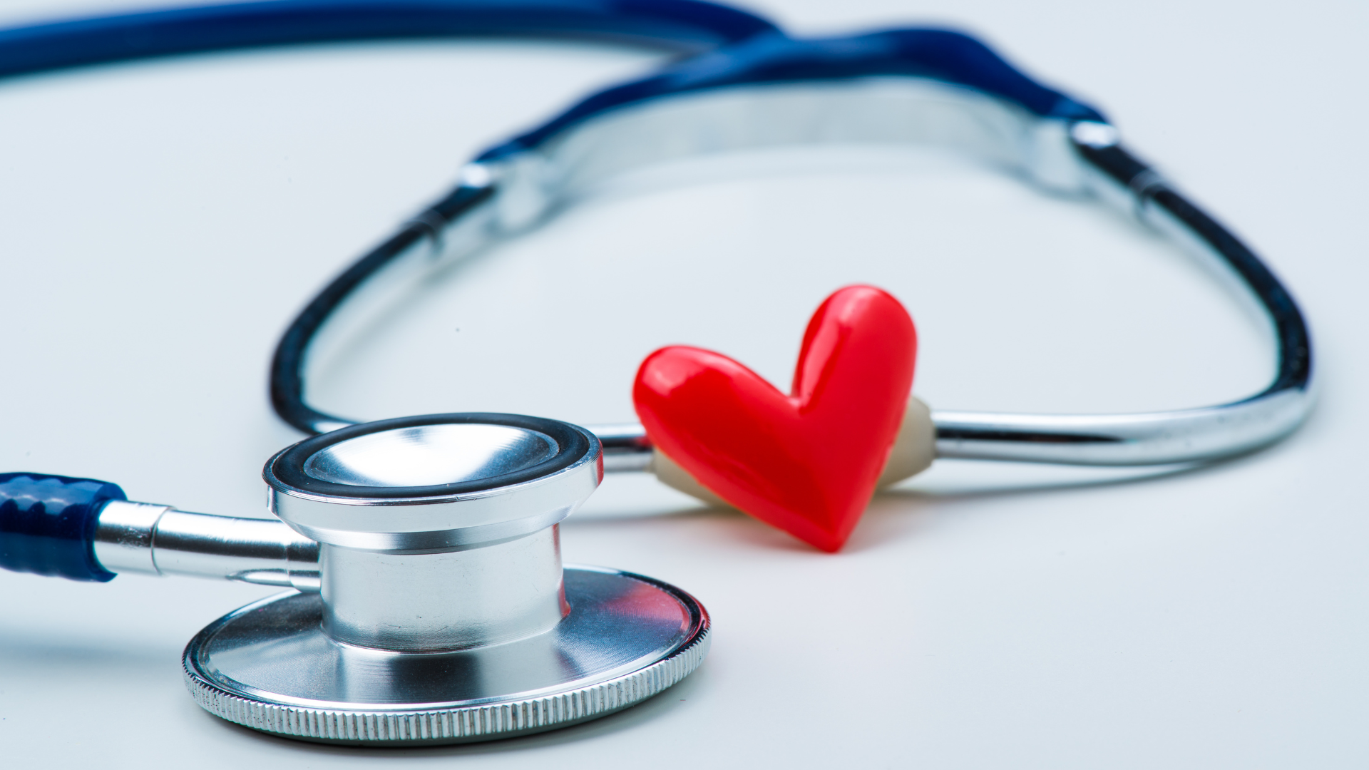 Close-up photo of a stethoscope with a red heart