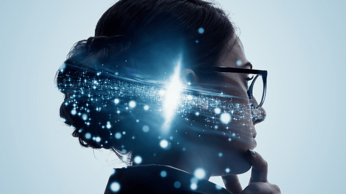 A conceptual digital image of a woman in profile, wearing glasses, with a futuristic overlay of glowing blue light particles and data streams emanating from her head.