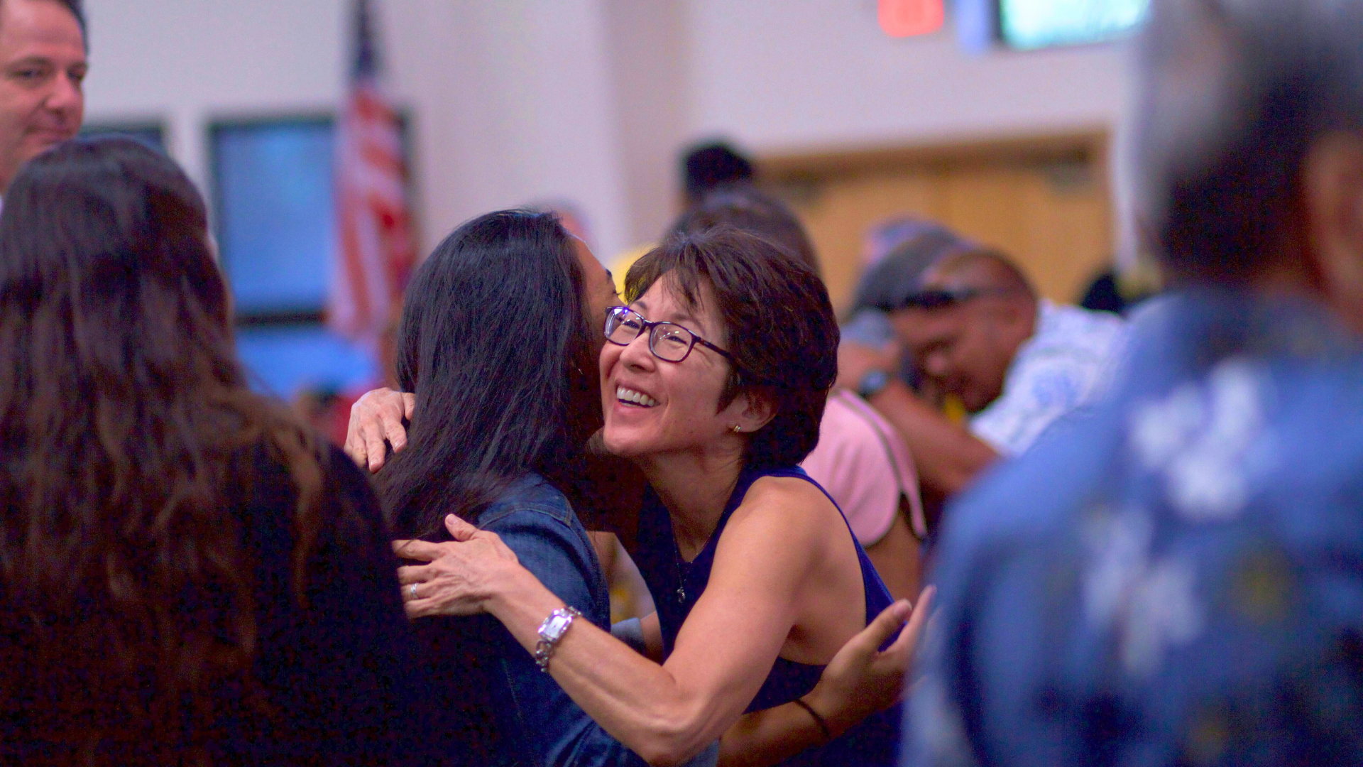 Concert attendees smiling and embracing after a concert