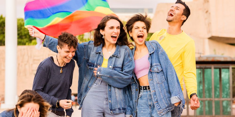 Group of friends with rainbow flag