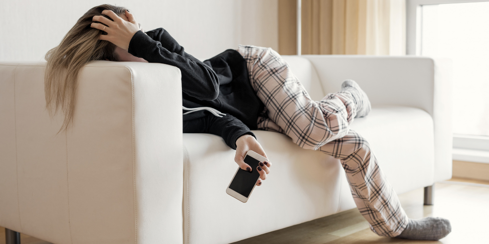 Mentally exhausted woman lying on a sofa