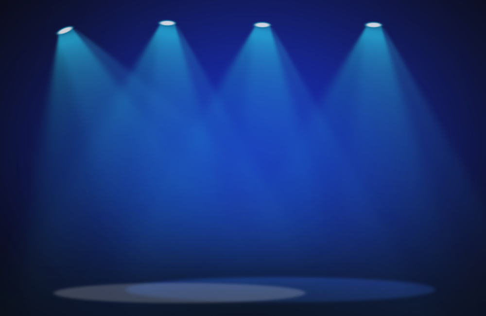 Empty stage with four blue spotlights