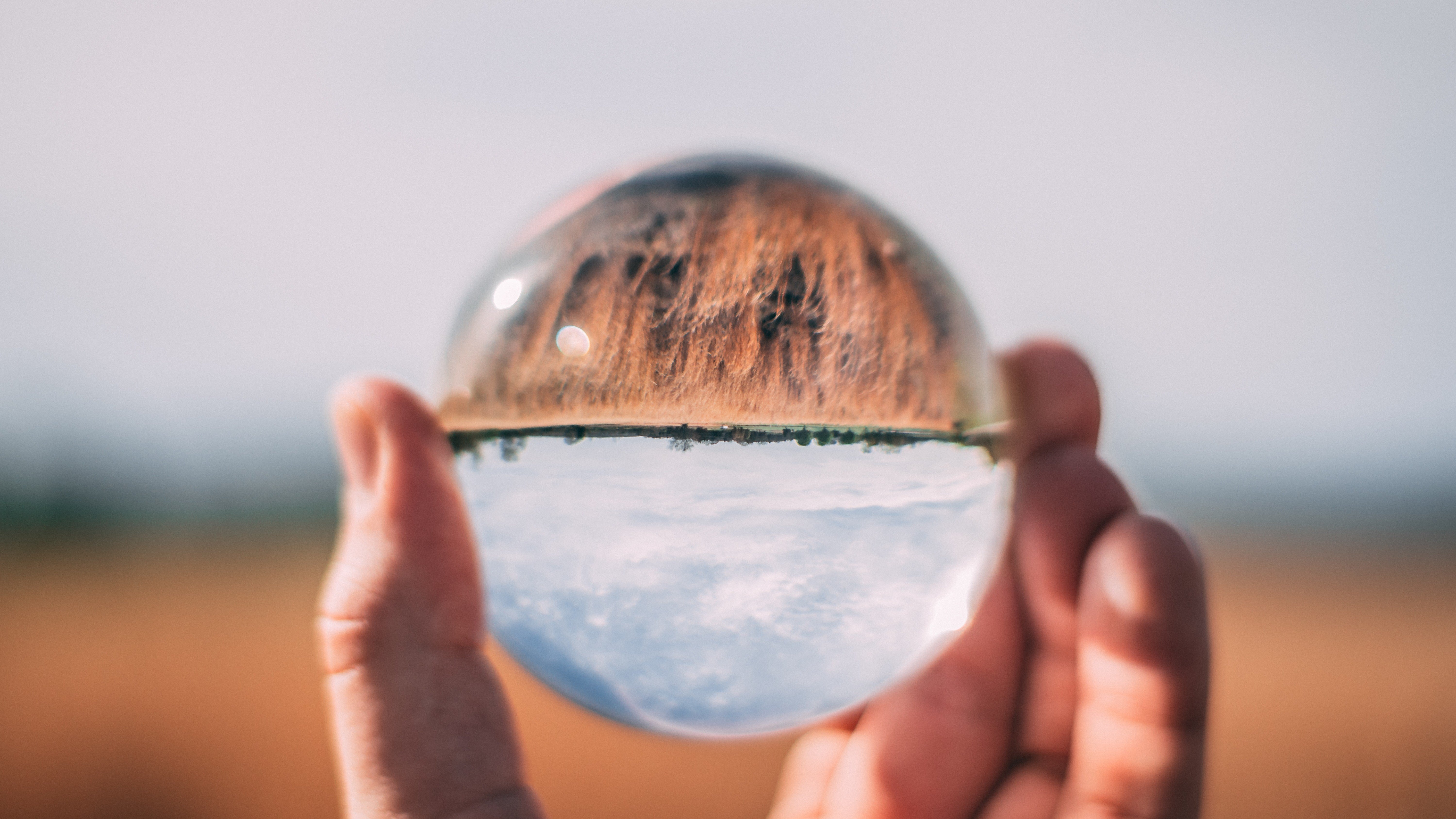 Close-up photo of person holding lens showing upside-down image