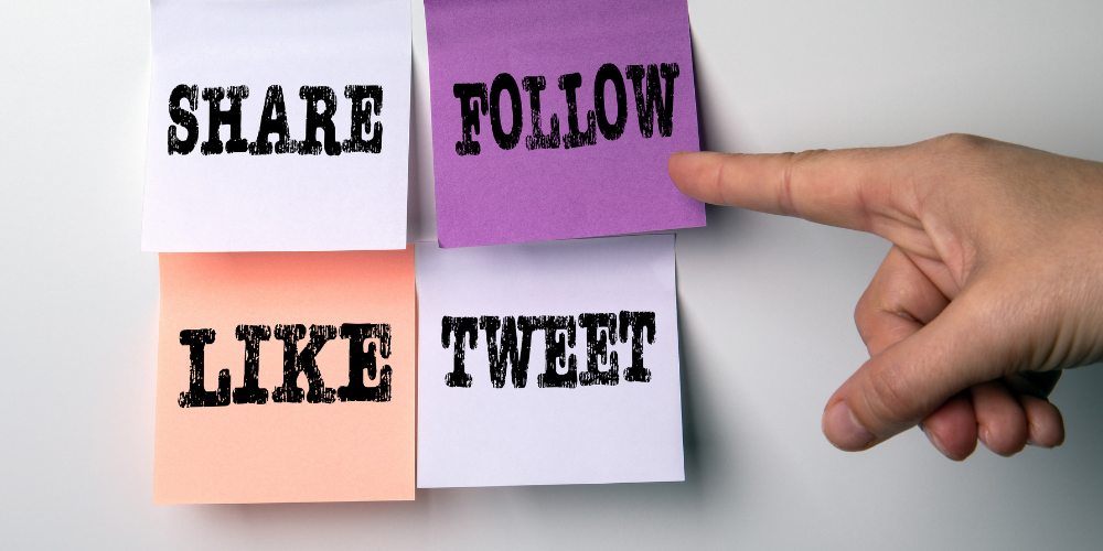 Hand pointing to sticky notes that say "Share," "Follow," "Like," and "Tweet."