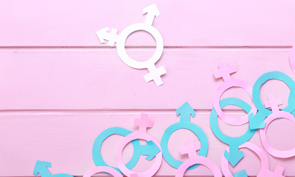 Transgender, Female and Male symbols on pink wooden background