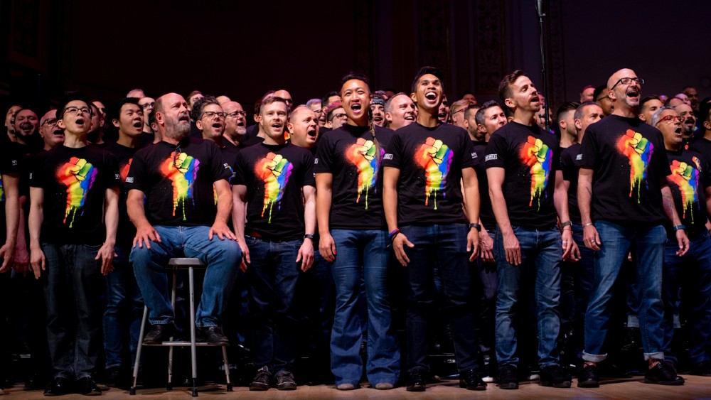 New York City Gay Mens Chorus singing in rainbow pride shirts