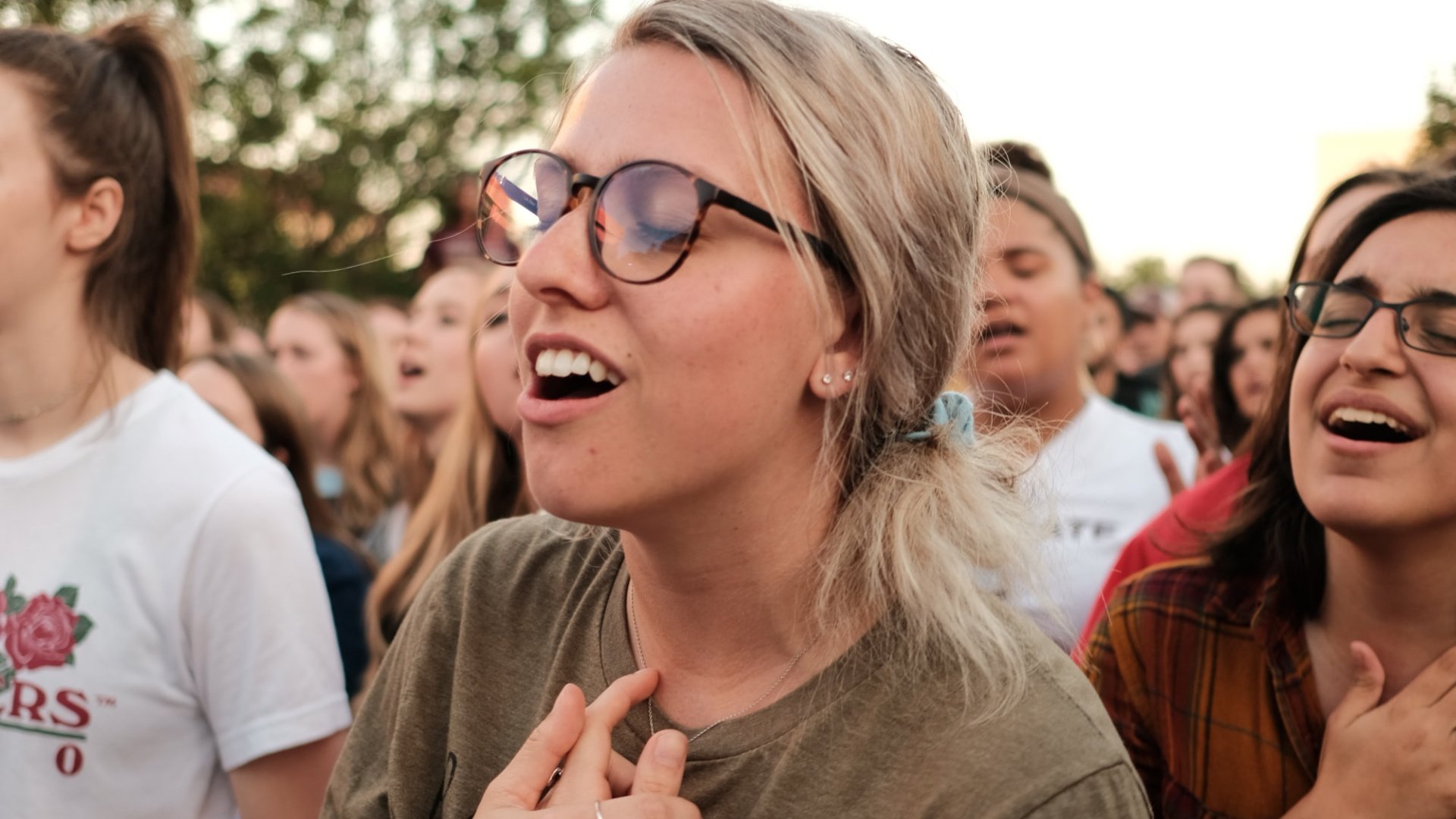 A group of young people standing together singing