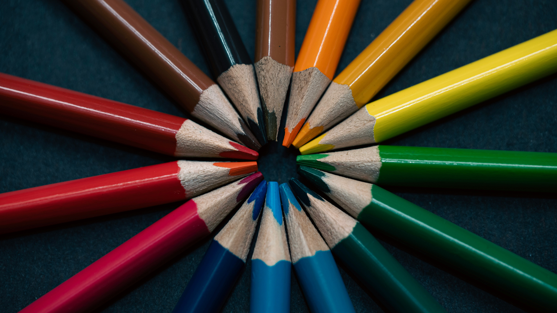 a group of colored pencils arranged in a circle