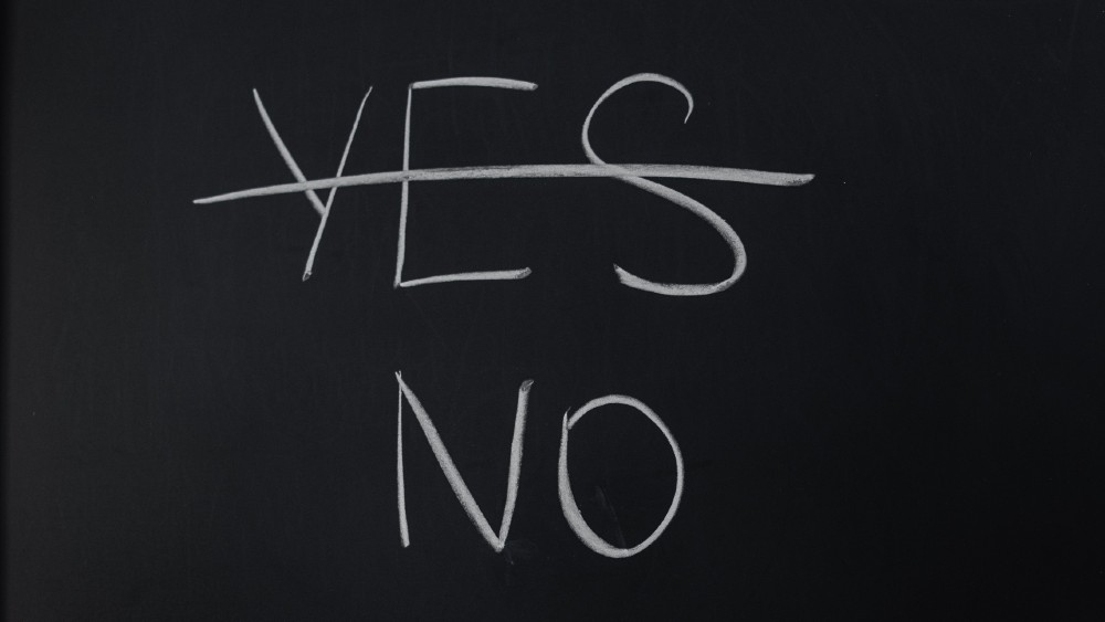 chalkboard with yes crossed out and no below