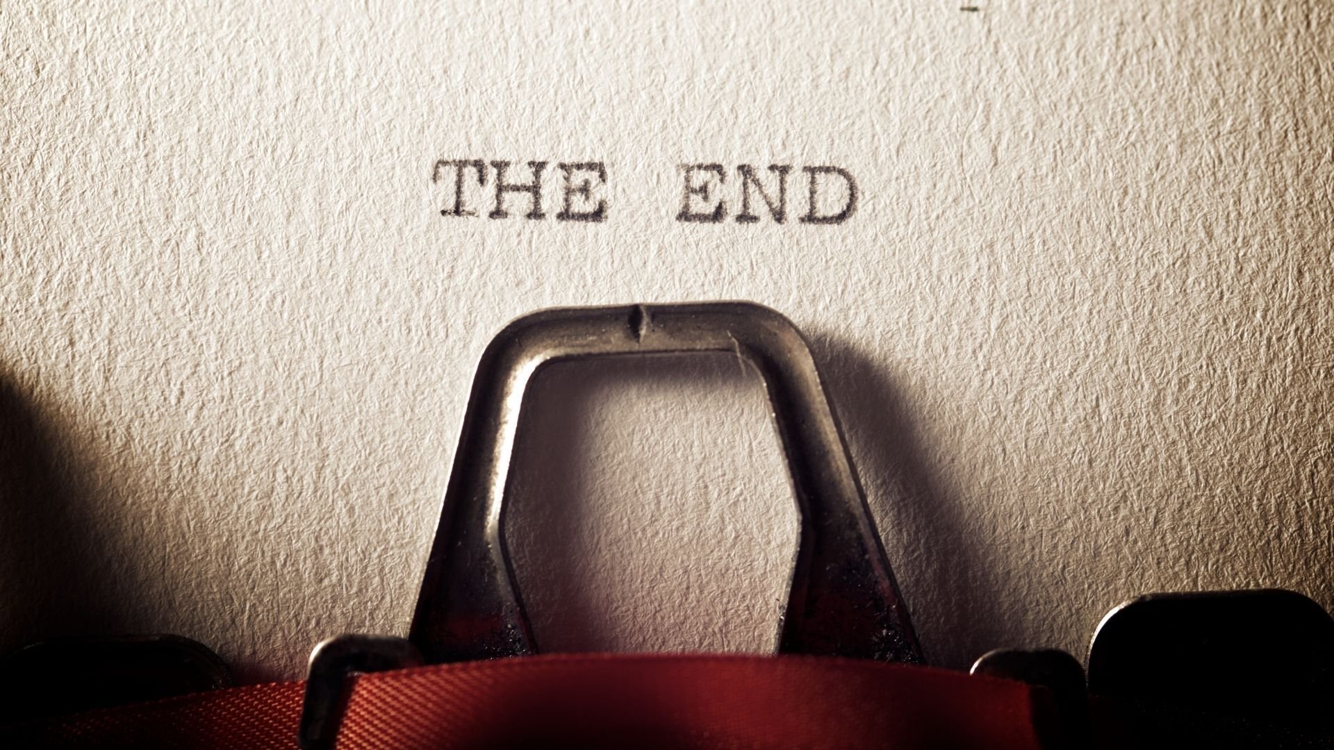 close up of paper in a typewriter that says the end