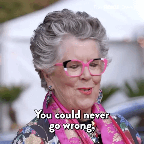 Grey haired woman in pink and black glasses saying 'you can never go wrong if you are just yourself'