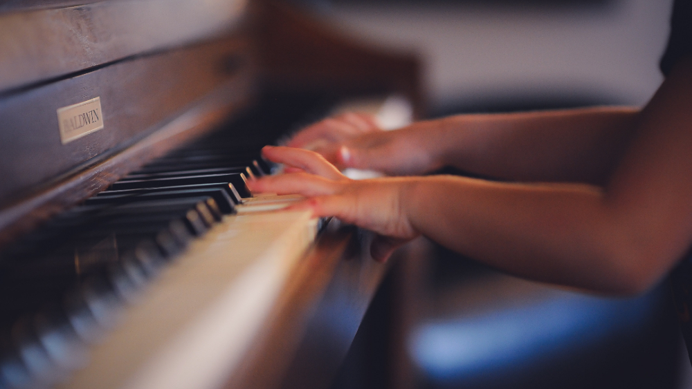 kid practicing piano