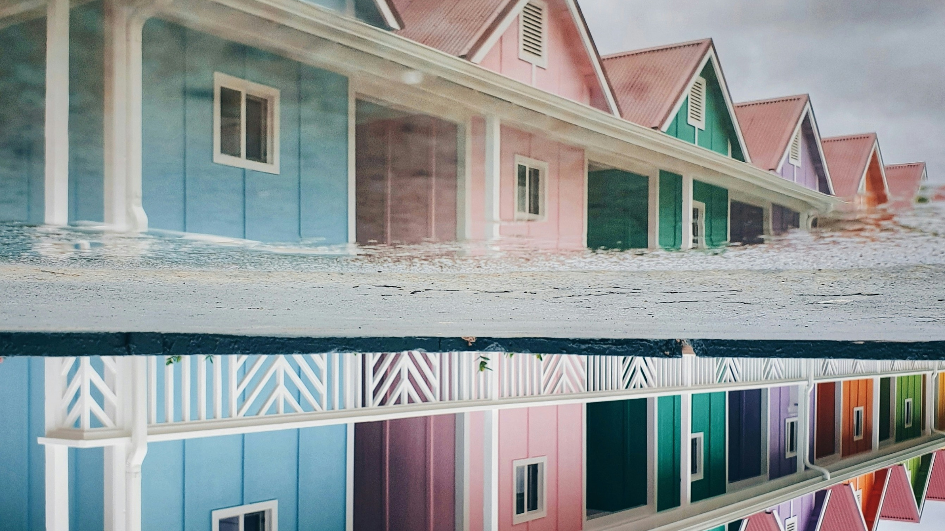 landscape photo of wooden houses with a reflection mirroring the image