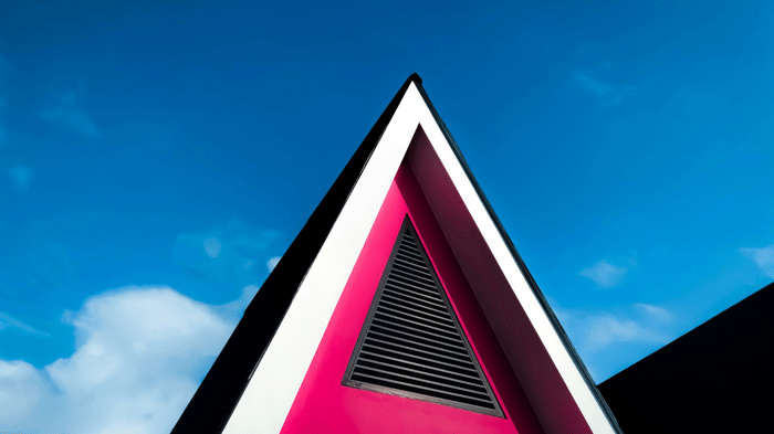 red and black  triangular building under blue sky during daytime