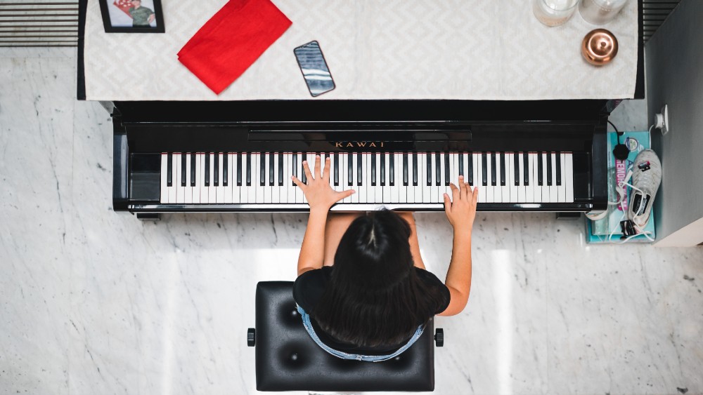 student practicing piano view from above