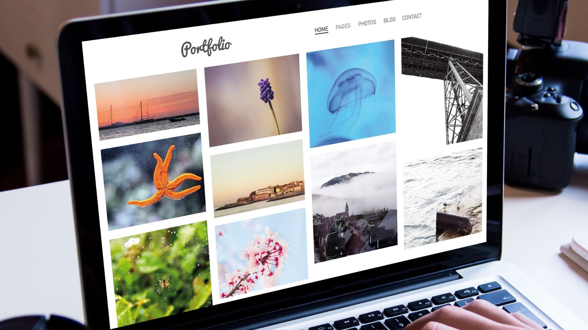 A colorful photography portfolio is displayed on the screen of a laptop