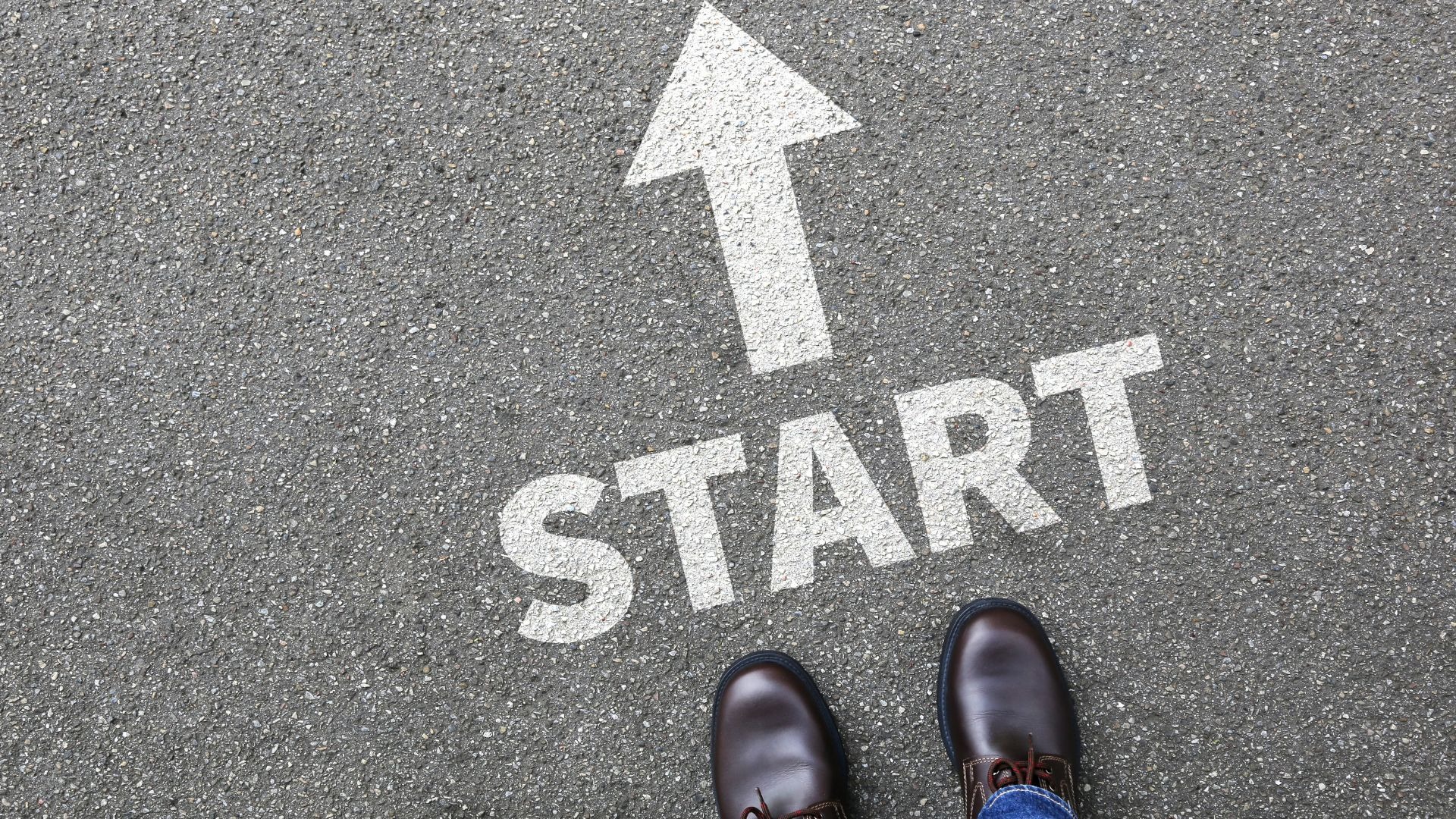 The word "start" with an arrow pointing forward is painted on pavement