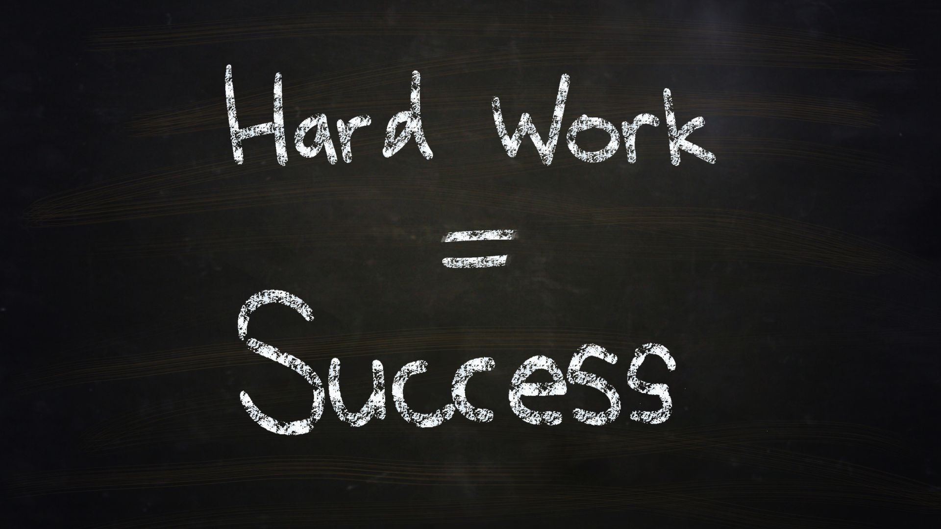 "Hard Work = Success" written in white on a black chalkboard